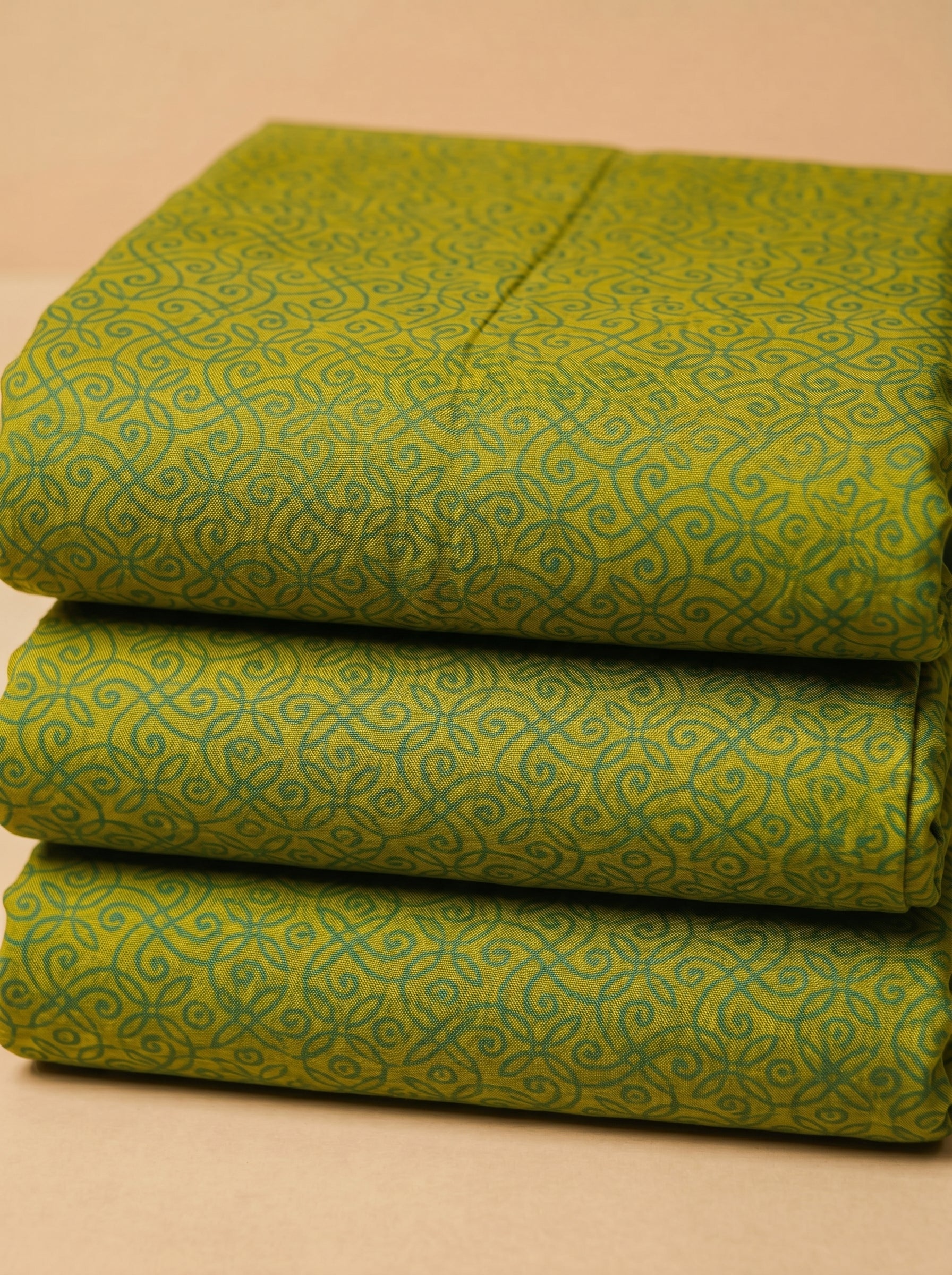 Full-width lime and teal ditsy floral fabric featuring high-density botanical motifs