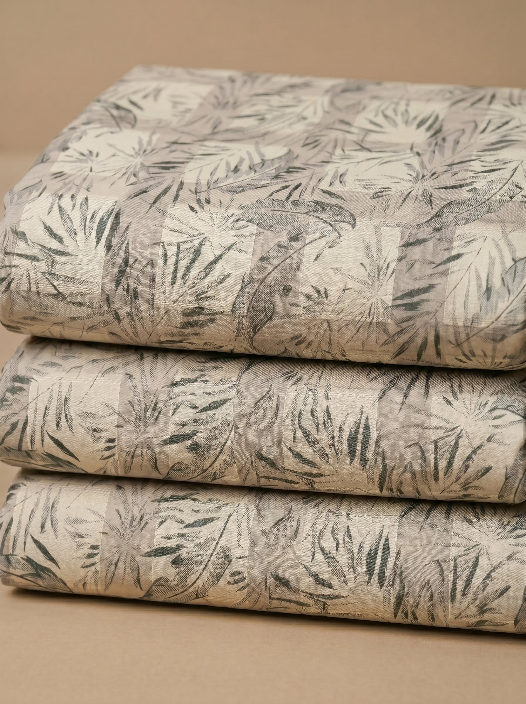 Unstitched Swiss voile featuring nature-inspired leaf motifs and intricate embroidery work