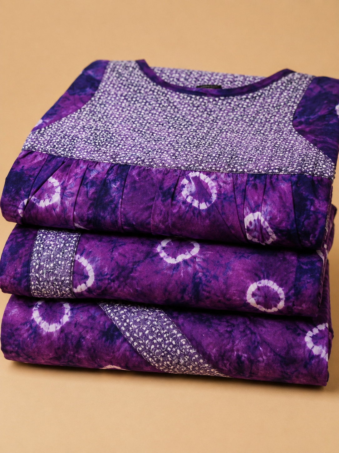 Tie-dye circles on a rich violet base