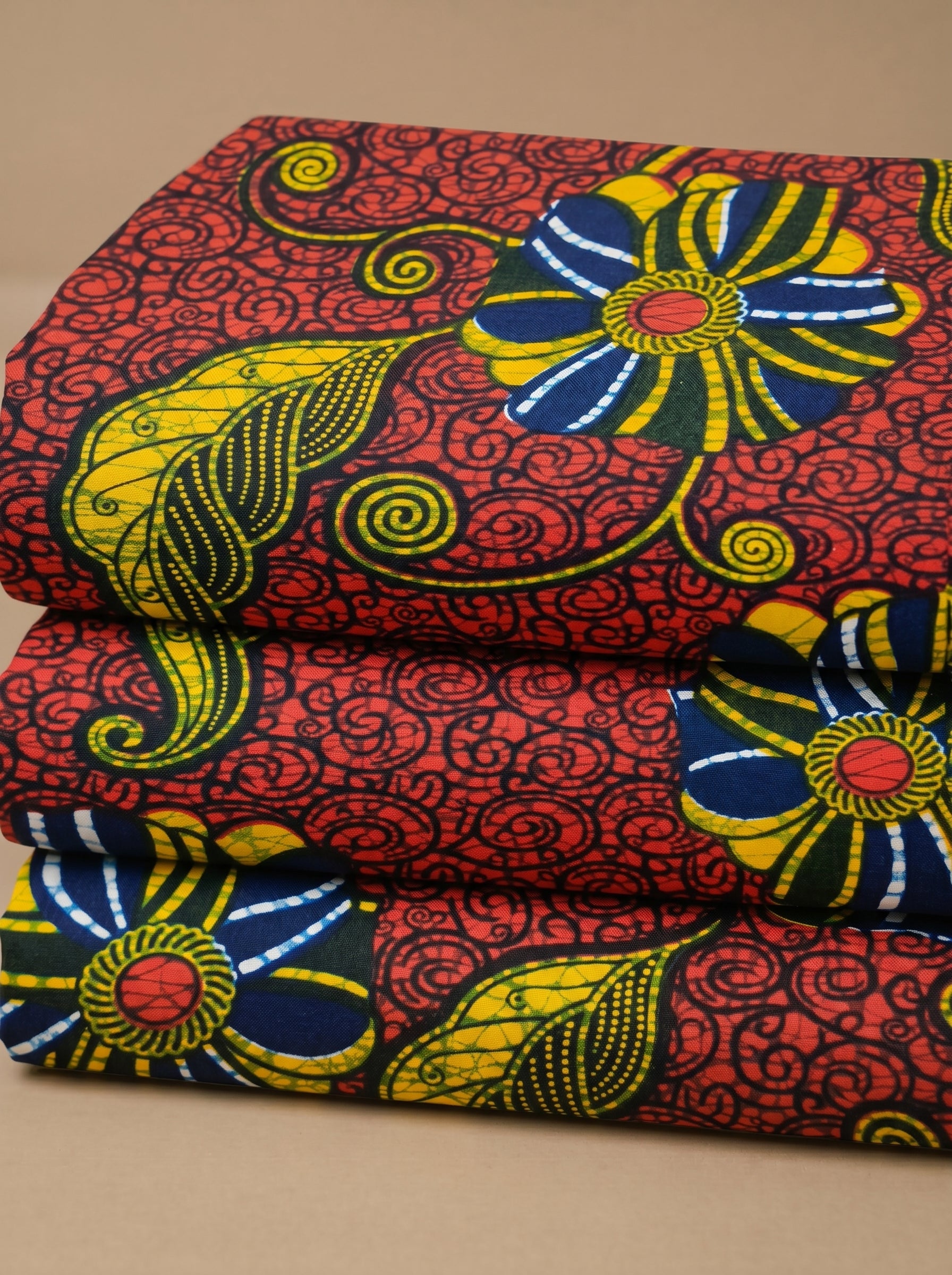 Bold floral wax print on rich red