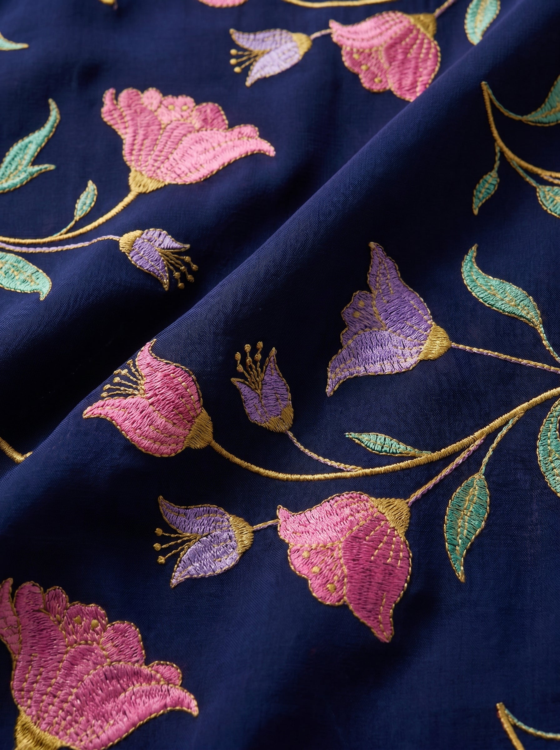 Vibrant floral embroidery on deep navy voile