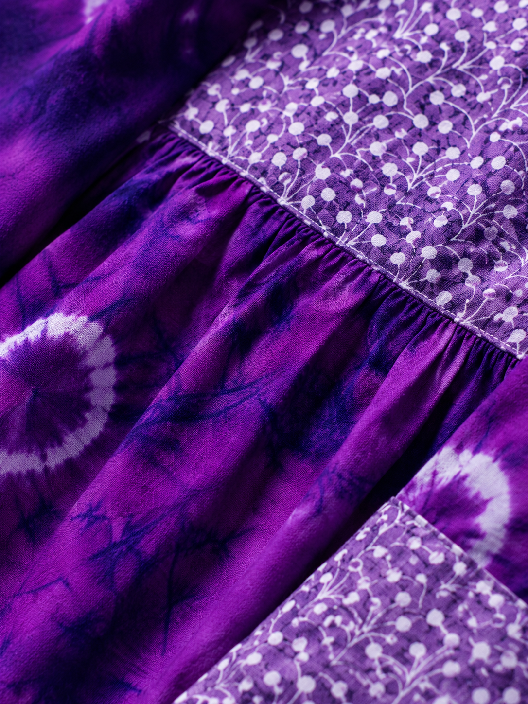 Tie-dye circles on a rich violet base