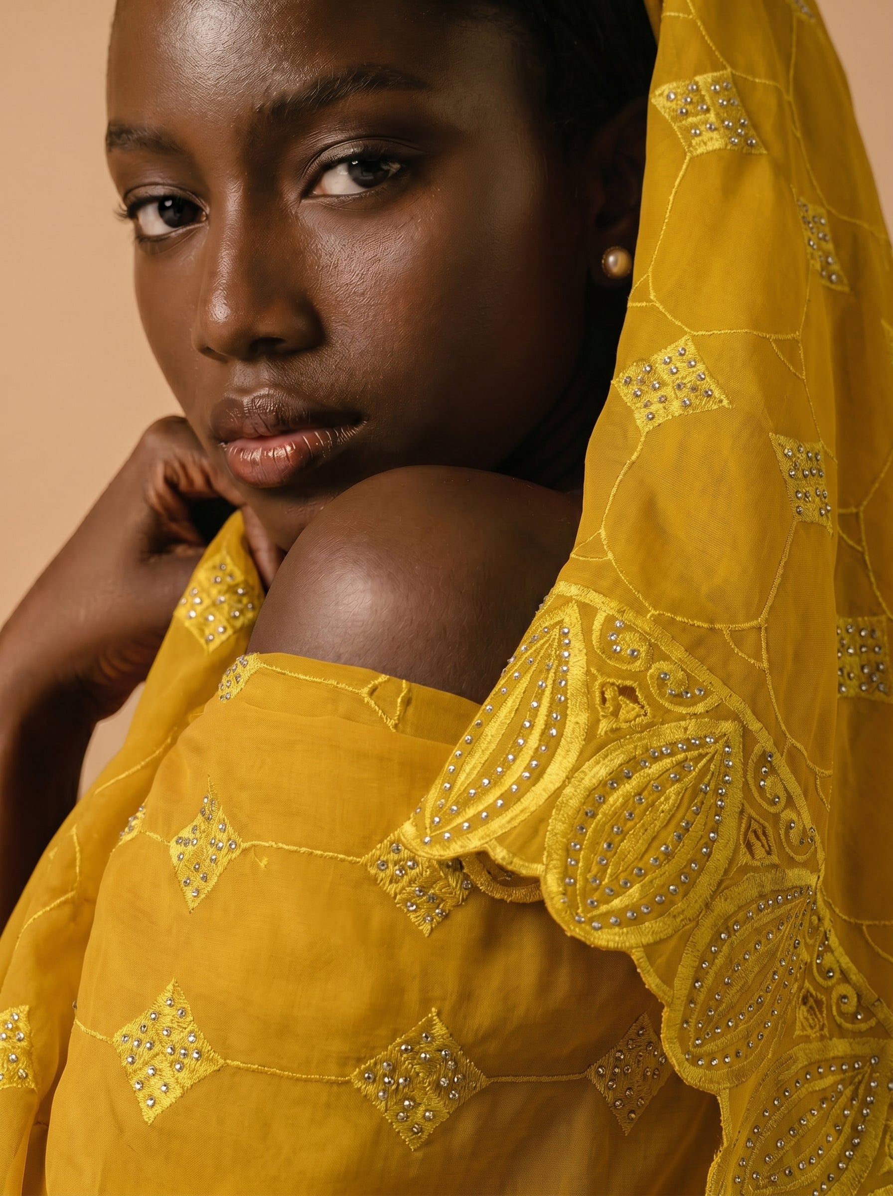 Vibrant mustard yellow Swiss voile featuring a structured diamond lattice pattern and ornate heavy-duty cutwork embroidery
