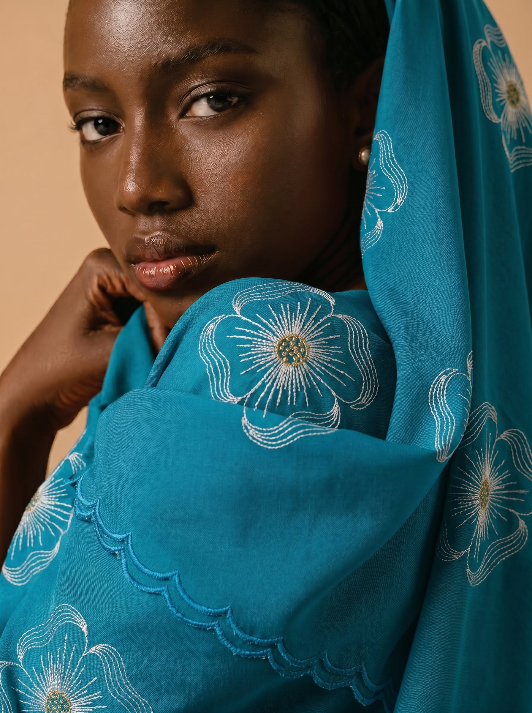 Premium azure blue Swiss voile featuring delicate cutwork floral embroidery and scalloped edges