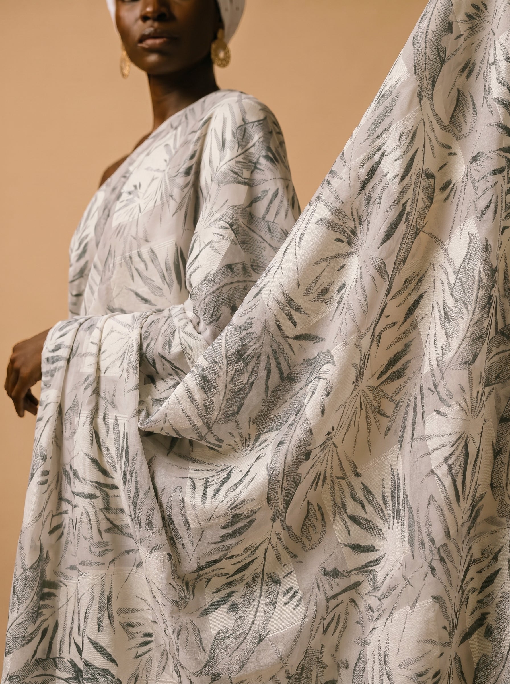 Unstitched Swiss voile featuring nature-inspired leaf motifs and intricate embroidery work