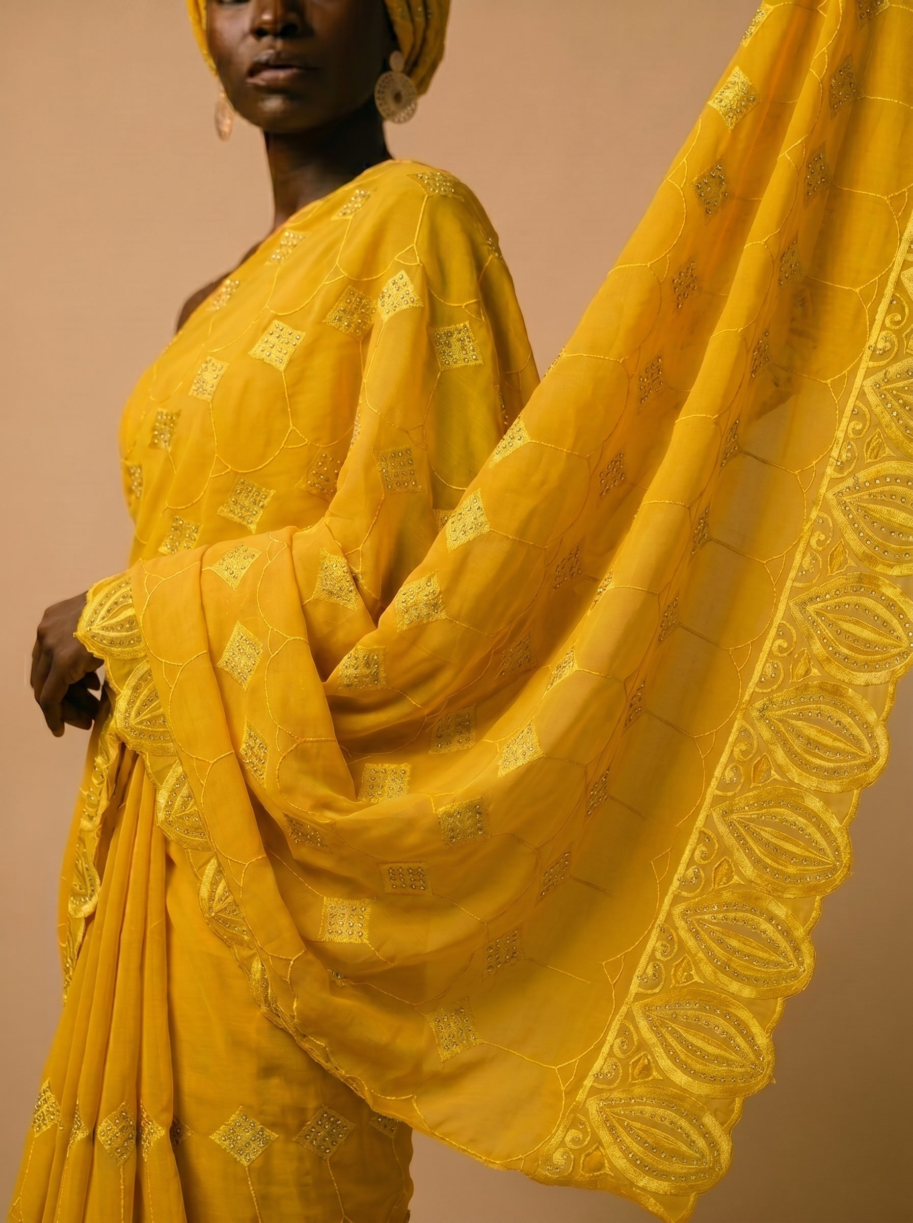Vibrant mustard yellow Swiss voile featuring a structured diamond lattice pattern and ornate heavy-duty cutwork embroidery