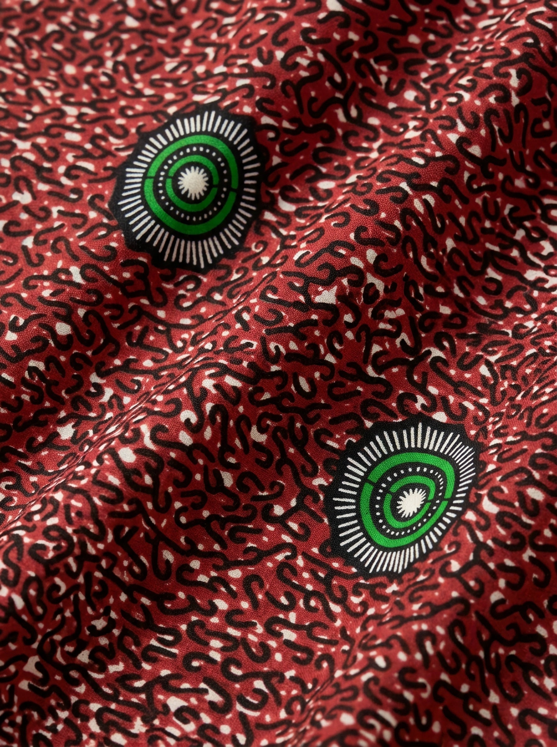 Emerald eyes on a fiery red canvas