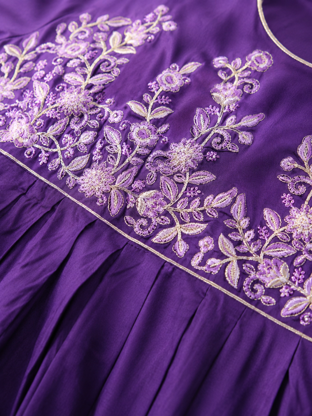Delicate floral embroidery on a rich royal purple base