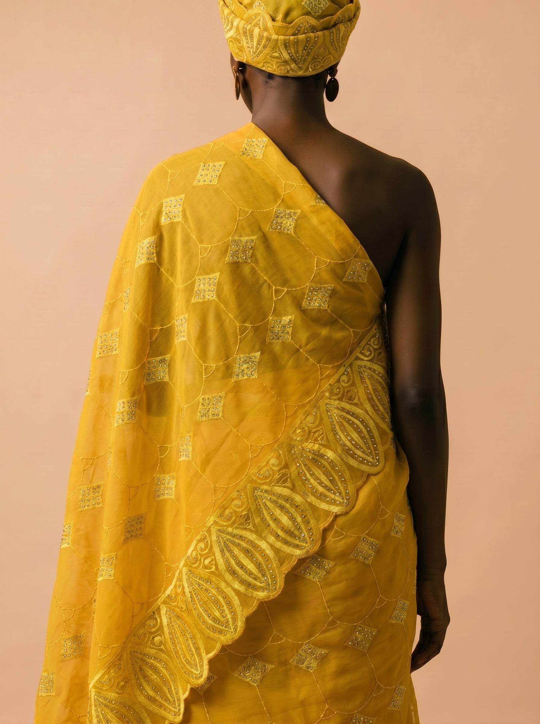 Vibrant mustard yellow Swiss voile featuring a structured diamond lattice pattern and ornate heavy-duty cutwork embroidery